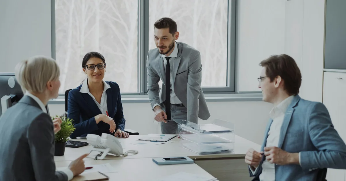 Sales team reviewing a pipeline on screen during a weekly meeting